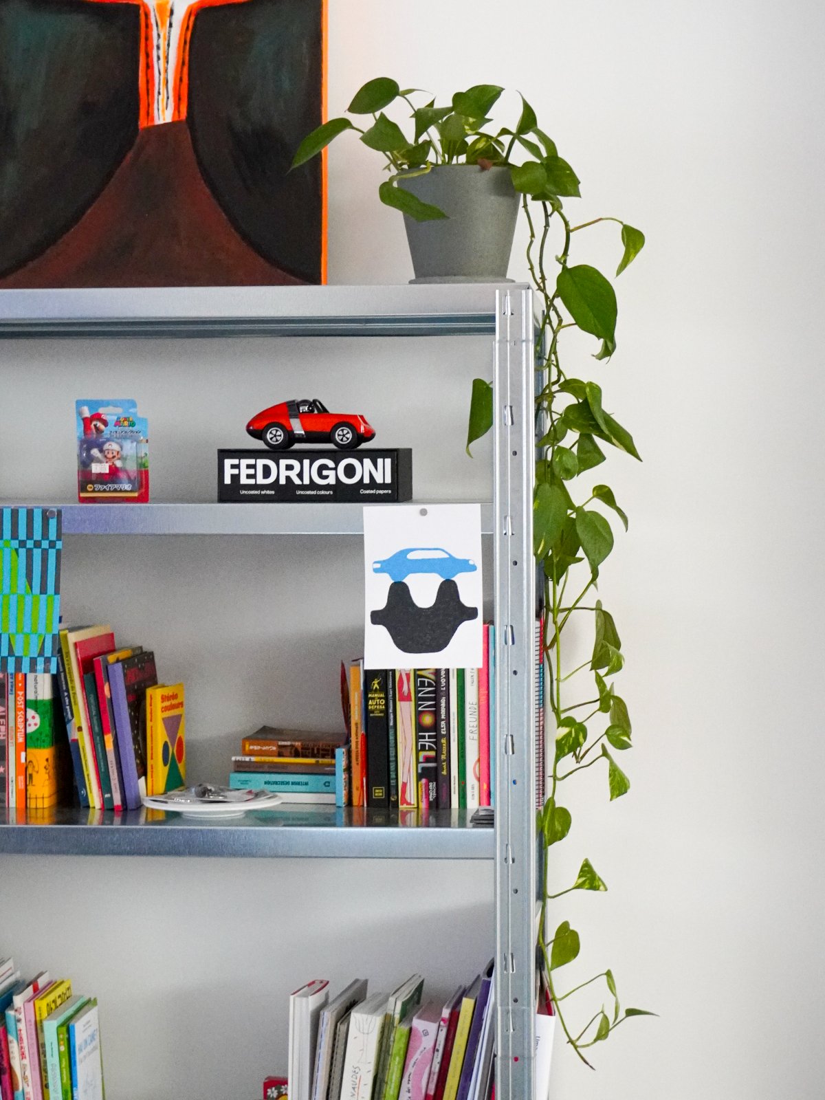Bookshelf with toys and a hanging plant